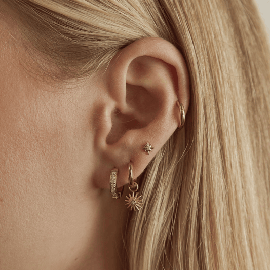 Gold Tone Huggie Hoop Earrings with Sunburst CZ Charms
